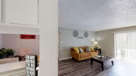 Located at 9350 S Padre Island Dr in Corpus Christi, Texas, this single-floor residence offers a well-organized and cohesive layout designed for comfortable everyday living. The living room features durable wood-look flooring, neutral gray walls, and a textured ceiling, creating a welcoming atmosphere. Decorative wall accents add character to the space, which is complemented by ceiling vents for climate control throughout.

The dining area is conveniently positioned adjacent to the kitchen, with matching wood-look flooring, a ceiling fan with integrated lighting, and a pass-through window connecting to the kitchen — an ideal setup for casual meals and entertaining.

The bedroom is carpeted for warmth and comfort, featuring soft gray walls, a ceiling fan with light fixture, and ample natural light from a window with blinds. The room offers generous space for furniture arrangement and includes ceiling ventilation for year-round comfort.

The bathroom is clean and functional, featuring a full tub-shower combination with a curtain rod, a vanity with a speckled countertop, and white fixtures throughout. The overall design of this residence is consistent and neutral, making it a move-in ready space with a practical, livable feel throughout.