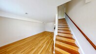 Located at 5308 Whetstone Rd in Richmond, Virginia, this two-story home offers four bedrooms and two bathrooms across a well-distributed layout. The main floor provides a comfortable living room with warm hardwood flooring, natural light streaming through a front-facing window, and a staircase leading to the upper level. The kitchen is well-appointed with white cabinetry, dark countertops, stainless steel appliances including a gas range, dishwasher, and refrigerator, plus a double sink and ample natural light from multiple windows. A closet and electrical panel are also conveniently located in the kitchen area. The upper floor houses the majority of the bedrooms, including a generously sized primary bedroom with plush carpeting and a large window overlooking the outdoors. Additional bedrooms feature hardwood flooring, natural light, and closet access. The bathrooms are clean and functional, with one featuring classic white subway tile surrounding a full tub-shower combination. Throughout the home, a neutral color palette, consistent hardwood flooring on the main level, and an abundance of windows contribute to a bright, airy atmosphere suited for comfortable everyday living.