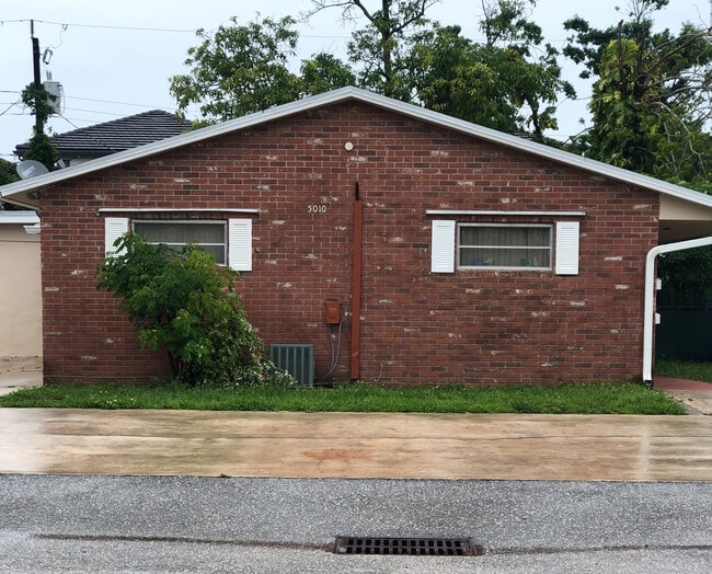 Exterior with two available parking spaces and an outdoor area for table/chairs and BBQ - 5010 SW 26th Ave House
