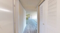 Located at 10305 Zackary Circle in Riverview, Florida, this single-floor, two-bedroom, two-bathroom residence offers a practical and well-organized layout. A central hallway with light wood-look flooring and a textured ceiling connects the main living areas, setting a clean and neutral tone throughout.

The combined kitchen and living room serves as the heart of the home. The kitchen features white cabinetry, light speckled countertops, a stainless steel sink, a gas range, a refrigerator, and a dishwasher, all finished with consistent light-toned flooring. A ceiling fan in the living area adds comfort, while vertical blinds on a large window allow for natural light and outdoor views.

Both bedrooms are carpeted and finished with neutral walls and textured ceilings. The primary bedroom is generously sized, offering ample space, and includes direct access to one of the two bathrooms. The second bedroom also benefits from natural light through a window with blinds. A dedicated closet provides additional storage within the unit.

Each bathroom features a tiled tub-shower combination, a single-sink vanity with white cabinetry, light countertops, and wood-look flooring, maintaining the clean, cohesive aesthetic found throughout the home. The straightforward layout and neutral finishes make this a functional and move-in-ready residence.