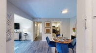 Located at 936 Mountain Creek Rd in Chattanooga, TN, this thoughtfully designed two-bedroom, three-bathroom residence offers a comfortable and stylish single-floor layout. Wood-look plank flooring runs throughout, creating a cohesive and contemporary feel across every room.

The living room is bright and welcoming, featuring a sliding glass door that opens to a private balcony overlooking lush greenery, allowing natural light to fill the space. The kitchen is well-appointed with two-tone cabinetry — white upper cabinets and charcoal lower cabinets — complemented by granite countertops and stainless steel appliances. It connects seamlessly to a dedicated dining room, ideal for everyday meals or entertaining.

The primary bedroom is generously sized, featuring a calming accent wall, large windows with natural light, and its own en-suite bathroom complete with a granite-topped vanity and bold navy cabinetry. The second bedroom is equally inviting, with ample natural light and neutral tones. A hallway and closet provide practical storage solutions.

Three full bathrooms serve the home, including one with a tub-shower combination. The overall design palette of soft blues, warm wood tones, and neutral grays gives the residence a modern yet comfortable ambiance throughout.