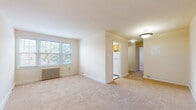 Located at 848 21st St NE in Washington, DC, this unit offers three bedrooms and one bathroom across a single floor. The layout is efficiently organized, connecting a living area, hallway, kitchen, and bedrooms in a functional flow. Neutral-toned walls and wall-to-wall carpet run throughout the living and bedroom areas, creating a warm and consistent aesthetic. Each bedroom features classic cast-iron radiators and windows dressed with blinds that invite natural light. The spacious primary bedroom includes two closets, providing generous storage. Additional bedrooms are well-proportioned, each with a window and radiator. The kitchen stands out with marble-style vinyl flooring, warm wood cabinetry, white tile backsplash, and a gas range, along with a window overlooking greenery. The bathroom is finished with white subway tile wainscoting, marble-style flooring, a vanity with a white countertop, a mirror cabinet, a bathtub, and a bright window. A hallway connects the main spaces, and the unit is accessed through a secure front door. Radiator heating is present throughout, reflecting the building's classic construction character typical of established Washington, DC neighborhoods.