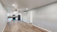 Located at 4040 E Dakota Ave in Fresno, CA, this thoughtfully updated single-story home offers two bedrooms and two bathrooms within a efficiently designed floor plan. Light-toned luxury vinyl plank flooring runs consistently throughout the entire space, creating a cohesive and modern aesthetic.

The open-concept living and kitchen area serves as the heart of the home. The kitchen is well-appointed with crisp white shaker cabinetry, dark countertops, a stainless steel sink, and a full suite of stainless steel appliances including a gas range, over-the-range microwave, and refrigerator. A window above the counter brings in natural light and provides a view of the exterior. The adjacent living area features recessed lighting and a ceiling fan, with a wall-mounted mini-split unit providing efficient climate control.

Both bedrooms are comfortably sized, with the primary bedroom offering its own mini-split unit and ample closet space. The second bedroom includes a ceiling fan and a window that fills the room with natural light. Three closets are distributed throughout the home for generous storage.

The bathrooms are finished to a high standard, with one featuring a glass-enclosed corner shower adorned with marble-style tile, a stylish vanity, and brushed nickel fixtures. The clean, neutral color palette of soft gray walls and white trim carries throughout the entire home, creating a bright and welcoming atmosphere.
