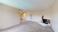 Located at 16818 Downey Ave in Paramount, California, this single-floor unit offers a practical and comfortable layout designed for everyday living. The living area is generously sized, featuring soft wall-to-wall carpeting, neutral warm-toned walls, and a textured ceiling. A ceiling fan provides overhead circulation, while a wall-mounted HVAC unit and a vertical register ensure year-round comfort. A sliding glass door opens to a private balcony, allowing natural light to fill the space and providing outdoor access.

The kitchen is efficiently designed with tile flooring, white cabinetry, light stone-finish countertops, and a window above the sink that brings in natural light. It is equipped with stainless steel appliances including a gas range with oven, an over-the-range microwave, and a dishwasher, making it fully functional for daily use.

The bedroom is a comfortable retreat featuring plush carpeting, a large window with vertical blinds, and a wall of mirrored sliding closet doors that enhance the sense of space and provide ample storage.

The bathroom includes a tiled floor, a combined tub and shower, a vanity with a stone-finish countertop, and a small window for ventilation and natural light. The overall aesthetic throughout is clean, neutral, and move-in ready.