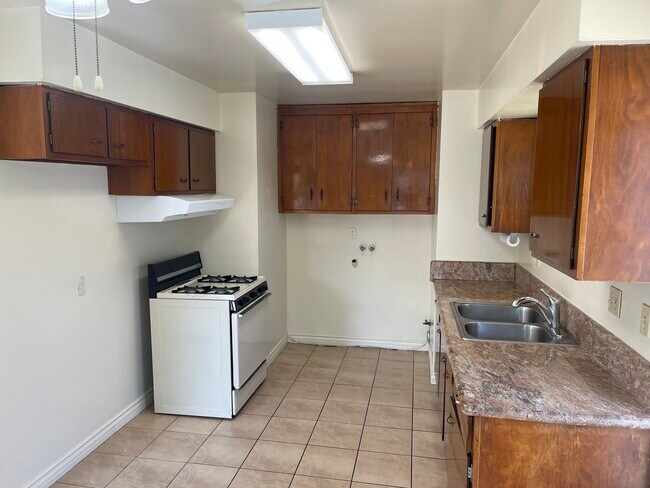 Kitchen Showing Laundry Hook-ups, Granite Counter Top and Range - 4703 W 173rd St