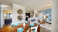 Located along US Highway 281 N in San Antonio, TX, this 1-bedroom, 2-bathroom residence offers a thoughtfully designed, single-story floor plan that makes excellent use of its space. The open-concept living, dining, and kitchen area forms the heart of the home, with wood-look flooring, track lighting, and a distinctive blue accent wall that adds a pop of color throughout. The kitchen features dark espresso cabinetry, granite countertops, a breakfast bar with bar seating, and black appliances including a refrigerator, range, and built-in microwave. The dining area is bathed in natural light from a large window and connects seamlessly to the living room, which includes a ceiling fan and a glass door opening onto a private patio. The bedroom is a comfortable retreat with plush carpeting, a ceiling fan, a blue accent wall, and access to two closets with built-in shelving. Both bathrooms are finished with dark cabinetry and granite countertops. A dedicated laundry room accommodates a full-size washer and dryer with additional shelving for storage. The overall ambiance is modern and inviting, with consistent finishes tying each room together cohesively.