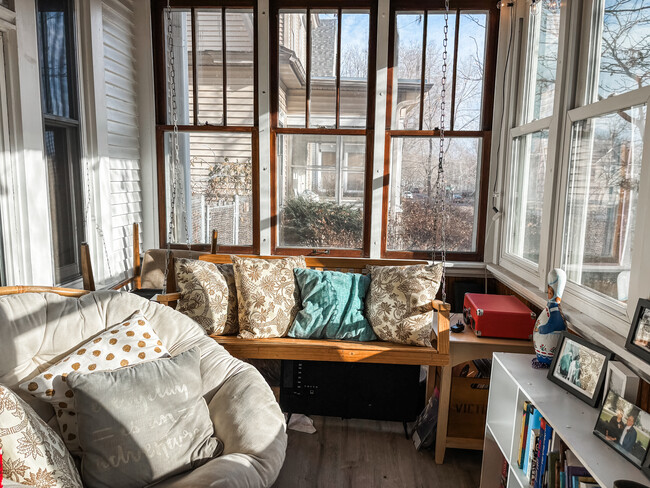 The south facing porch is a cozy spot to enjoy morning coffee, chat with friends, or read a book. - 819 Edmund Ave