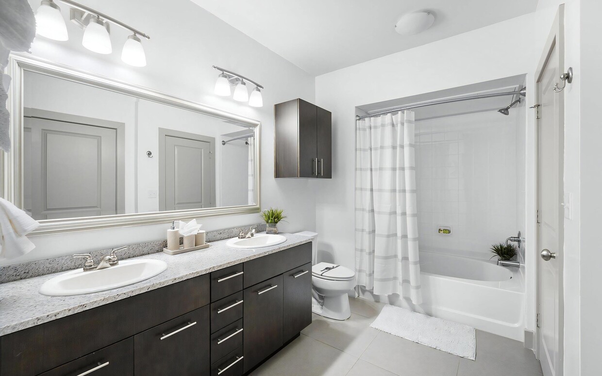 Bright Bathroom with Dual Vanities, Tile Floors, and Shower-Tub Combo - The Landing at Vinnin Square