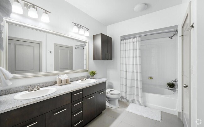 Bright Bathroom with Dual Vanities, Tile Floors, and Shower-Tub Combo - The Landing at Vinnin Square
