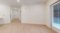 Located at 3311 Hood Ave in Chamblee, GA, this well-appointed single-story home offers a thoughtfully designed layout with 1 bedroom, 2 bathrooms, and generous living space across one level. The open-concept living, dining, and kitchen area is bright and welcoming, featuring light wood-tone flooring, recessed lighting, and crisp white walls throughout. The kitchen is a standout feature, equipped with full stainless steel appliances including a french door refrigerator with ice maker, electric range, over-the-range microwave, and dishwasher, all complemented by sleek gray shaker-style cabinetry and clean white countertops. The living area extends to a set of glass French doors that open to an outdoor space, filling the room with natural light. The bedroom is carpeted for comfort, includes a ceiling fan, and benefits from natural light through a window. It connects to a spacious walk-in closet with wire shelving, providing ample storage. The bathrooms are clean and modern, with light wood-tone flooring and neutral finishes. Additional features include a dedicated laundry area, multiple closets for storage, and an entrance with direct access. The overall aesthetic is clean, modern, and move-in ready.