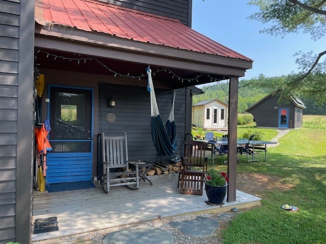 Side porch with view of back patio, sauna, and office building - 223 Huntley Rd