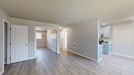 Located at 3044 G St in Merced, California, this single-story, 2-bedroom, 1-bathroom home offers a clean and modern interior with consistent light wood-look flooring and neutral gray walls throughout. The open living area flows naturally into the kitchen, which features gray shaker-style cabinetry, light quartz-style countertops, recessed lighting, and stainless steel appliances including a gas range and refrigerator. A textured ceiling is present throughout the home, adding a classic residential character. The primary bedroom is a well-proportioned retreat with a dedicated closet, while the second bedroom includes mirrored sliding closet doors and benefits from natural light through a window with outdoor views of surrounding greenery. Both bedrooms are equipped with wall-mounted AC units. The full bathroom is finished with a vanity featuring a quartz-style countertop, gray cabinetry, and a tub-shower combination enclosed by sliding frosted glass doors. The home also includes a patio, providing an outdoor space ideal for relaxation. Clean white trim and six-panel doors are consistent details throughout, contributing to a cohesive, updated aesthetic across the entire home.
