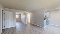 Located at 3044 G St in Merced, California, this single-story, 2-bedroom, 1-bathroom home offers a clean and modern interior with consistent light wood-look flooring and neutral gray walls throughout. The open living area flows naturally into the kitchen, which features gray shaker-style cabinetry, light quartz-style countertops, recessed lighting, and stainless steel appliances including a gas range and refrigerator. A textured ceiling is present throughout the home, adding a classic residential character. The primary bedroom is a well-proportioned retreat with a dedicated closet, while the second bedroom includes mirrored sliding closet doors and benefits from natural light through a window with outdoor views of surrounding greenery. Both bedrooms are equipped with wall-mounted AC units. The full bathroom is finished with a vanity featuring a quartz-style countertop, gray cabinetry, and a tub-shower combination enclosed by sliding frosted glass doors. The home also includes a patio, providing an outdoor space ideal for relaxation. Clean white trim and six-panel doors are consistent details throughout, contributing to a cohesive, updated aesthetic across the entire home.