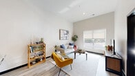 Located at 100 E National Ave in Milwaukee's vibrant Walker's Point neighborhood, this one-bedroom, one-bathroom unit offers a well-designed layout across a single floor. The open-concept kitchen and living area serves as the heart of the space, featuring soaring ceilings and large windows that flood the room with natural light and provide views of the surrounding area. The kitchen is equipped with light maple cabinetry, dark countertops, stainless steel appliances—including a full-size refrigerator and range—and a breakfast bar with pendant lighting overhead, offering both functionality and a casual dining option. The living area is bright and inviting, with light hardwood-style flooring that extends throughout the unit. The bedroom is a comfortable retreat with its own window, continuing the unit's neutral, modern palette and natural light. The bathroom features light maple cabinetry paired with a white countertop vanity, large-format tile flooring, and dark-finished doors that add a contemporary contrast. A dedicated walk-in closet with wire shelving provides practical storage. Throughout the unit, clean lines, neutral tones, and modern finishes create a cohesive and functional living environment.