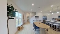 This contemporary two-story residence in Rowlett, Texas, offers 1,610 square feet of thoughtfully designed living space. The home boasts three bedrooms and four bathrooms, providing ample room for comfortable family living or entertaining guests. The ground floor spans 650 square feet, while the upper level offers 960 square feet of space.

The heart of the home is a sleek, modern kitchen featuring white cabinetry, stainless steel appliances, and a large center island, perfect for meal preparation or casual dining. The adjacent living room is bright and airy, with large windows allowing natural light to flood the space. Indoor plants add a touch of nature, enhancing the room's welcoming ambiance.

The primary bedroom is generously sized at 220 square feet, featuring a ceiling fan and ample windows for ventilation and natural light. The decor is tasteful, with a mix of warm wood tones and soft textiles creating a cozy retreat.

An office space is included, ideal for remote work or study, with a well-designed desk area and views to the outside. The home also includes a walk-in closet with built-in shelving for organized storage.

Bathrooms are modern and functional, with clean lines and neutral color schemes. Throughout the home, the use of light colors, hardwood and carpeted floors, and carefully chosen artwork contributes to a cohesive and contemporary aesthetic. The property's layout and design make efficient use of space, creating a comfortable and stylish living environment.