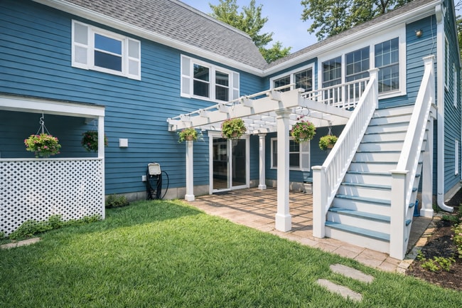 Outdoor patio area with pergola and deck, perfect for relaxing or enjoying warm weather - 16 Miller Rd