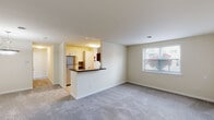 Located at 26 Cheswold Blvd in Newark, Delaware, this single-floor residence offers a clean, functional layout designed for comfortable everyday living. The open-concept living area is spacious and bright, featuring neutral-toned carpet, crisp white walls, and a window that allows natural light to filter in with views of the surrounding neighborhood. A kitchen peninsula with a dark countertop serves as a natural divider between the living space and the kitchen, maintaining an open and connected feel throughout.

The kitchen is well-appointed with white cabinetry, dark countertops, light wood-style flooring, and stainless steel appliances including a refrigerator, microwave, and range. A window above the sink brings in additional natural light, and a tall storage cabinet provides ample pantry space.

The bedroom is comfortably sized, featuring the same soft carpeting found throughout the living area, a window with blinds offering outside views, and direct access to a closet. The full bathroom is finished with light tile flooring, a vanity with white cabinetry and a white countertop, a toilet, and a tiled shower-tub combination. Clean lines and neutral tones carry consistently throughout the residence, creating a cohesive and practical living environment.