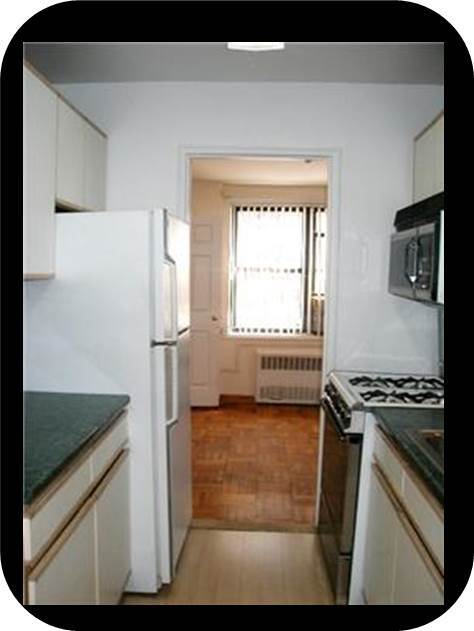 Galley kitchen looking to Bedroom #2 (Now has new gas range and microwave) - 6495 Broadway