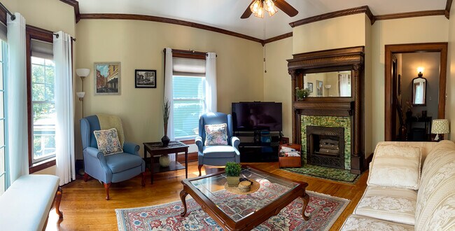 [Living Room] Spacious room with large windows, provides a beautiful view of a tree-lined street. - 103 Lancaster Ave
