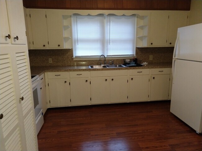 Large kitchen, new oven, new refrigerator with ice maker, washer, hamper, plenty of cabinet space and shelving, double sink, wood laminate floor - 4800 Matthews-Mint Hill Rd