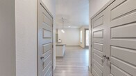 This well-designed 2-bedroom, 2-bathroom residence in Denver, CO offers a thoughtful single-floor layout with modern finishes throughout. The open-concept kitchen and living area serves as the heart of the home, featuring a large central island, dual-tone cabinetry with white upper and rich dark lower cabinets, a classic subway tile backsplash, stainless steel appliances including a refrigerator, range, and microwave, and stylish pendant lighting. Light wood-style flooring flows throughout the main living areas, adding a clean, contemporary feel. The primary bedroom is a comfortable retreat, complete with a ceiling fan and access to a well-appointed en-suite bathroom. The primary bath offers both a soaking tub and a glass-enclosed shower, tile surround, a vanity with undermount sink, and direct access to a walk-in closet with built-in shelving and hanging rods. The second bedroom features plush carpet, a ceiling fan, and a bright window with natural light. The second bathroom includes a glass-enclosed shower, tile surround, and a matching vanity. Both bedrooms are served by dedicated closets with organized storage. The living area opens to a private outdoor space via glass French doors, allowing abundant natural light to fill the room.