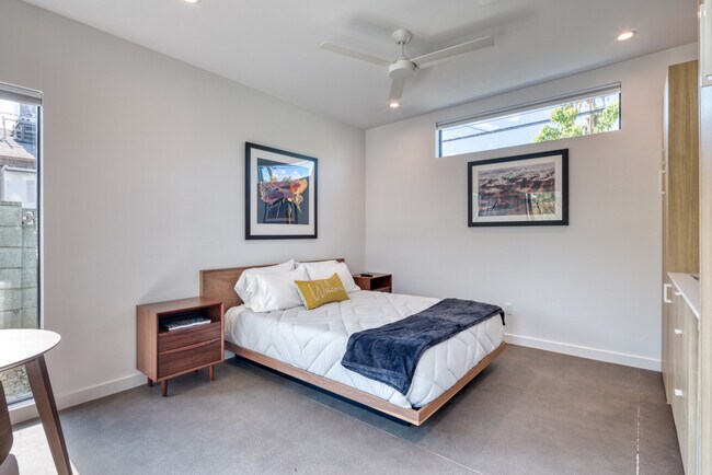 Large studio bedroom space with a ceiling fan. - 4711 N 14th St