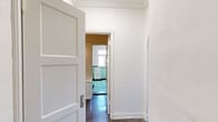 Located on James M Wood Boulevard in Los Angeles, this one-bedroom, one-bathroom unit blends vintage character with modern updates across a single floor. The layout includes a bedroom, bathroom, combined dining room and kitchen, and a hallway connecting the spaces.

The spacious bedroom is a standout feature, boasting polished concrete floors that reflect natural light, elegant crown molding, a built-in closet, a classic cast-iron radiator, and a charming arched doorway that adds architectural interest. A decorative white fireplace anchors the living area, flanked by two windows that invite ample natural light and views of the surrounding neighborhood.

The kitchen has been thoughtfully updated with white shaker cabinetry, dark countertops, a subway tile backsplash, stainless steel appliances including a gas range, and a double-basin sink — all set atop polished concrete floors. The dining area adjoins the kitchen, offering a practical and connected layout.

The bathroom retains its vintage charm with mint-green tile, black tile accents, white fixtures, and a bright window. Adjacent to the bathroom, a built-in white vanity with a decorative mirror and wall sconce adds a refined touch. A hallway with paneled doors and ornate crown molding ties the home together with timeless detail.