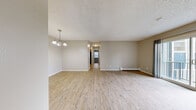 Located at 1620 Coronado Pkwy S in Denver, CO, this two-bedroom, one-bathroom unit offers a functional and comfortable single-floor layout. The living room is bright and open, featuring light wood-style flooring, a textured ceiling, a chandelier, baseboard heating, and a wall-mounted AC unit. Sliding glass doors lead directly to a private balcony, bringing in natural light and outdoor access. The kitchen is well-equipped with warm honey-toned cabinetry, ample upper and lower storage, a double-basin sink, and black appliances including a range, dishwasher, and refrigerator. Both bedrooms are carpeted and feature textured ceilings and generous closet space with sliding bi-fold doors, providing practical storage. The bathroom includes a single-sink vanity with a mirrored medicine cabinet, a tiled shower surround with a marble-like finish, and clean white finishes throughout. With four closets spread across the unit, storage is plentiful. The neutral color palette and consistent finishes give the space a cohesive, move-in-ready feel suited for comfortable everyday living in the Denver area.