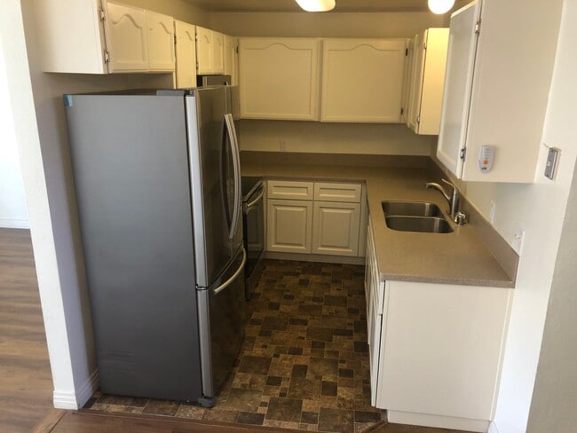 Building Photo - Beautiful Townhome with large fenced back patio, second story balcony, and two covered parking spots