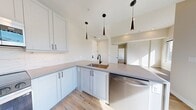 This contemporary 1-bedroom apartment in Denver, CO, offers 620 square feet of thoughtfully designed living space. The open floor plan maximizes the use of space, creating a seamless flow between the living areas. The bedroom, measuring 180 square feet, provides ample room for rest and relaxation.

The apartment features sleek hardwood flooring throughout, complemented by crisp white walls that enhance the sense of spaciousness. Large windows flood the rooms with natural light and offer panoramic views of the surrounding cityscape, adding to the urban appeal.

The modern kitchen is a highlight, boasting white cabinetry, stainless steel appliances, and a chic marble-look backsplash. A central island with a built-in sink serves as both a functional workspace and a casual dining area.

The bathroom continues the contemporary aesthetic with a marble-patterned shower surround, modern fixtures, and a vanity with ample storage. A ceiling fan in the main living area provides both style and comfort.

This apartment combines efficiency with style, making it an ideal choice for urban professionals or anyone seeking a modern, low-maintenance living space in the heart of Denver.