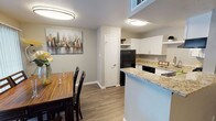 Located at 66 Daughtrey Ave in Waco, Texas, this single-floor residence offers a thoughtfully designed layout that balances comfort and functionality. The kitchen is outfitted with crisp white shaker-style cabinetry, granite countertops, a stainless steel sink, and black appliances including a refrigerator, dishwasher, and range. A peninsula counter provides a natural transition into the adjacent dining area, which features wood-look flooring and a sliding glass door with vertical blinds that allows for natural light. The living room centers around a classic fireplace and is finished with the same durable wood-look flooring, neutral gray walls, and a sliding glass door that brings in additional light. Both bedrooms are carpeted for comfort and include ceiling fans with light fixtures. The primary bedroom features a window that allows natural light to filter in, while both rooms offer a calm, neutral palette. The bathroom includes a tub-shower combination, granite-topped vanity, and clean white fixtures. Throughout the home, a consistent neutral color scheme and wood-look flooring in the main living areas create a cohesive, move-in-ready atmosphere.