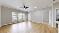 This 600 square foot apartment in Franklin, Tennessee offers a thoughtful layout maximizing space and functionality. The single-floor plan includes one bedroom, measuring 130 square feet, and one bathroom. The heart of the home is an open-concept kitchen and living area, creating a seamless flow for daily living and entertaining.

Throughout the apartment, light wood-tone flooring adds warmth and continuity. Large windows, equipped with white blinds, allow natural light to flood the spaces, enhancing the sense of openness. The neutral color palette, predominantly in soft grays and whites, creates a fresh and modern ambiance.

The bedroom features a spacious closet with wire shelving, offering ample storage. The bathroom boasts a contemporary design with a gray vanity, framed mirror, and modern fixtures. In the kitchen, sleek gray cabinetry is complemented by white countertops and a subway tile backsplash. Stainless steel appliances, including a built-in oven and range, add a touch of sophistication.

Ceiling fans in the main living areas and bedroom provide air circulation and comfort. The apartment also includes a separate laundry area, adding convenience to daily life. With its efficient use of space and updated finishes, this apartment offers a comfortable and stylish living environment in a prime Franklin location.