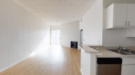 Located at 500 S Lake St in the heart of Los Angeles, this single-floor residence offers a well-planned layout with a bright, open-concept living and dining area. The main living space features light wood-style flooring, a textured ceiling, and a sleek fireplace as a focal point, complemented by a sliding glass door that invites natural light and provides outdoor access. A pendant light fixture illuminates the dining area near the entryway, which is finished with the same warm hardwood-style flooring.

The kitchen is thoughtfully designed with white cabinetry, light stone-style countertops, a stainless steel gas range with overhead ventilation, a dishwasher, and a peninsula that opens toward the living area, creating a seamless flow between spaces.

The bedrooms are finished with plush carpeting and feature vertical blind-covered windows that allow for adjustable natural light. Sliding closet doors and direct access to adjacent spaces add to the functional layout visible in the floor plan.

The bathroom is clean and modern, equipped with a tub-shower combination enclosed by a sleek sliding glass door and chrome fixtures. Throughout the residence, bright white walls and an abundance of natural light contribute to a fresh, airy ambiance ideal for comfortable urban living.