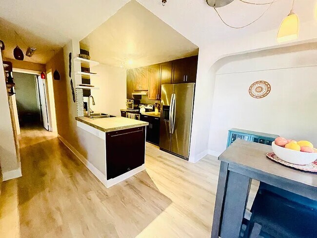 Open concept kitchen with polished concrete counter-tops and modern splashback - 140 Uwapo Rd