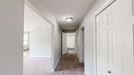 Located at 1719 Foxon Rd in North Branford, CT, this single-floor home offers a practical and comfortable layout with three bedrooms, one full bathroom, and four closets providing ample storage throughout. The interior is finished with neutral gray walls and clean white trim, creating a consistent and cohesive look across all rooms. Soft carpeting runs through the bedrooms and hallway, while the kitchen and bathroom feature durable tile flooring. The kitchen is equipped with white cabinetry, a coil-burner electric range, a dishwasher, and a sink positioned beneath a window that lets in natural light — with enough space to accommodate a dining area. The bedrooms are generously proportioned, with the primary bedroom being notably spacious, offering multiple windows that allow natural light to fill the room. The additional bedrooms each feature windows with outdoor views. A central hallway connects the bedrooms and bathroom, maintaining a clean flow throughout the home. The full bathroom includes a tub-shower combination, a toilet, and a white vanity with a sink, finished with stone-look tile flooring. With four closets distributed across the home, storage is practical and accessible.