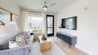 Located at 8801 Old Hickory Trail in Dallas, TX, this well-appointed one-bedroom, one-bathroom residence offers a cohesive modern design throughout its efficiently utilized single-floor layout. Light wood-style flooring flows seamlessly across all rooms, complemented by neutral wall tones that create a bright and welcoming ambiance.

The kitchen serves as a functional centerpiece, featuring a granite-topped island with seating, two-tone cabinetry pairing white upper cabinets with dark lower units, a classic subway tile backsplash, stainless steel appliances, and pendant lighting overhead. The living room is generously windowed with access to a private outdoor patio, offering views of the landscaped community grounds, pool area, and open green space — ideal for enjoying natural light and outdoor scenery.

The bedroom is a calm retreat, benefiting from large windows with outdoor views, a ceiling fan, and warm wood flooring. The bathroom is well-equipped with a granite-topped vanity, dark wood cabinetry, a glass-enclosed shower, and direct access to a walk-in closet outfitted with multiple shelving tiers and hanging rods. The overall design balances practicality with contemporary style, making efficient use of every square foot.