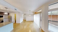 Located in Cedar Park, TX, this single-story, one-bedroom, one-bathroom home offers a thoughtfully designed layout that maximizes every square foot. Polished concrete floors flow consistently throughout the living areas, dining room, kitchen, and bedroom, lending a clean, contemporary aesthetic to the entire space.

The open living and dining area is bathed in natural light, courtesy of large windows and a sliding glass door dressed with vertical blinds. A pendant light anchors the dining area, while built-in shelving along one wall provides functional storage and display space.

The kitchen is well-equipped, featuring rich dark wood cabinetry, granite countertops, stainless steel appliances including a gas range, microwave, and refrigerator, a built-in wine rack, and a peninsula with pendant lighting — ideal for casual dining or meal prep.

The spacious primary bedroom includes crown molding, multiple windows for natural light, and direct access to a walk-in closet. The full bathroom offers a tiled soaking tub with shower combination, a glass block window for natural light, and clean, neutral finishes. A connecting hallway ties all rooms together efficiently, completing this well-organized and comfortable Cedar Park home.