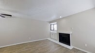 This single-story, 2-bedroom, 2-bathroom home offers a thoughtfully arranged floor plan that maximizes every square foot. The living room serves as the heart of the space, featuring warm wood-look laminate flooring, a textured ceiling, and a classic white-mantled fireplace that adds character and comfort. A wet bar area with cabinetry is conveniently positioned nearby, and a window allows natural light to brighten the room.

The kitchen is efficiently designed with white shaker-style cabinetry, light countertops, a double basin sink, and black appliances including a refrigerator, range, dishwasher, and over-the-range microwave — all set on light wood-look flooring.

Both bedrooms are carpeted and feature ceiling fans with light kits and windows with blinds that bring in natural light. The primary bedroom offers a comfortable, well-proportioned layout. The bathrooms include a full tub-shower combo with white tile surround, and a vanity bathroom with a marble-look quartz countertop, an undermount sink, and a large framed mirror. Additional storage cabinetry is present throughout. A dedicated laundry room with overhead cabinetry and electrical panel access completes the home's practical interior offerings.