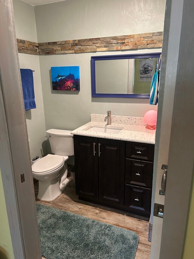 Bathroom off family room. - 5720 Sweetwater Blvd