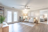 Located at 400 Eden Roc Cir in Virginia Beach, Virginia, this single-floor residence offers a well-designed layout that balances comfort and modern style. The living room serves as the heart of the home, featuring warm wood-look flooring, crown molding, a ceiling fan, and a set of French doors that invite natural light and provide outdoor access. The open, airy feel of the space is complemented by neutral gray tones on the walls.

The kitchen is outfitted with white shaker-style cabinetry, granite countertops, and a full suite of stainless steel appliances, including a range, microwave, and dishwasher. The dining area adjacent to the kitchen offers a comfortable setting with crown molding and track lighting overhead.

The primary bedroom features plush carpeting, a walk-in closet, and a private en-suite bathroom with granite countertops and a shower. Additional bedrooms are equally well-appointed with soft carpeting, ample closet space, and warm, welcoming finishes. A second full bathroom with wood-look flooring and clean, neutral finishes serves the remaining rooms.

Throughout the home, a cohesive palette of soft grays, warm wood tones, and crisp white trim creates a bright and inviting ambiance suited to the coastal Virginia Beach setting.