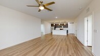 Located at 101 Mirano Way in Nokomis, Florida, this single-floor home offers four bedrooms and two bathrooms within a well-designed, open layout. The combined kitchen and living area serves as the heart of the home, featuring light wood-style flooring that flows throughout. The kitchen is outfitted with gray shaker-style cabinetry, stainless steel appliances including a refrigerator, electric range, microwave, and dishwasher, along with a central island with a white countertop and built-in sink, accented by a modern pendant light above. The spacious living area benefits from a ceiling fan and access to a private balcony, allowing natural light to fill the room. Each bedroom is bright and airy, with large windows fitted with blinds, ceiling fans, and the same cohesive wood-style flooring. The primary bedroom includes double closet doors, providing generous storage. Both bathrooms feature dark-toned vanity cabinetry with white countertops and a shower-tub combination. A dedicated laundry room houses a full-size GE washer and dryer, adding everyday convenience. Clean white walls, recessed lighting, and consistent finishes throughout give this home a fresh, modern aesthetic.