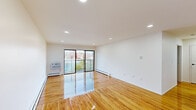 Located at 1207 Blue Spring Rd in Princeton, NJ, this single-floor unit offers a clean, modern aesthetic throughout. The expansive main living area is anchored by richly polished hardwood floors that reflect natural light, recessed ceiling lighting, and baseboard heating. Large sliding glass doors open directly onto a private balcony, filling the space with generous outdoor views and daylight.

The kitchen is thoughtfully equipped with white shaker-style cabinetry, stainless steel appliances including a range, over-the-range microwave, and refrigerator, all set over light-toned flooring that complements the bright, airy design.

The bedrooms continue the hardwood flooring theme and offer notable closet storage, including rooms with double closets featuring built-in wire shelving, as well as additional pantry-style closets with multi-tiered shelving for versatile organization.

Two bathrooms serve the unit: one features large-format marble-style wall tiles, a soaking tub, and matte black fixtures for a refined finish; the other offers a glass-enclosed stand-up shower with marble surround and a matching matte black showerhead and controls. Both bathrooms are tastefully updated with a cohesive, contemporary design that ties the overall aesthetic of the unit together.