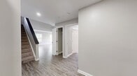 This contemporary townhouse in Bradlee Danvers offers a spacious 1,480 square feet of living area spread across two floors. The ground floor, encompassing 1,070 square feet, showcases an open-concept design that seamlessly integrates the kitchen, living, and dining areas. The kitchen boasts sleek white cabinetry, stainless steel appliances, and a convenient island with a sink.

Large windows throughout flood the space with natural light, while neutral-toned walls and wood-look vinyl flooring create a modern, cohesive aesthetic. The residence features two well-appointed bathrooms, both with white fixtures, tiled shower/tub combinations, and ample storage.

Upstairs, the 410-square-foot second floor houses two bedrooms, including the primary suite measuring 190 square feet. Each bedroom offers generous closet space and large windows. Additional amenities include a staircase connecting both levels, a hallway for easy navigation, and extra storage options.

The property's clean lines, minimalist design, and functional layout make it an ideal contemporary living space, perfect for those seeking a low-maintenance yet stylish home.