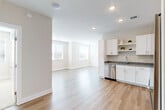 This well-appointed 2-bedroom, 2-bathroom residence in Aurora, CO offers a thoughtfully designed single-floor layout with modern finishes throughout. Light-toned luxury vinyl plank flooring flows through the main living areas, complemented by neutral wall tones and recessed lighting that create a bright, welcoming atmosphere.

The open-concept kitchen and living area serves as the heart of the home. The kitchen is equipped with crisp white shaker cabinets, granite countertops, a full suite of stainless steel appliances including a refrigerator, range, microwave, and dishwasher, and open shelving for display. Large windows in the living area allow generous natural light to fill the space.

Both bedrooms feature plush wall-to-wall carpeting, ceiling fans, and windows with blinds that bring in natural light. The primary bedroom connects directly to an en-suite bathroom, offering added privacy and convenience. Both bathrooms are finished with white cabinetry, granite countertops, and tile shower surrounds. A dedicated closet provides additional storage.

A welcoming entry hallway leads through the unit, offering a clean transition between rooms. The overall design aesthetic is contemporary and neutral, making it a versatile and move-in ready residence.