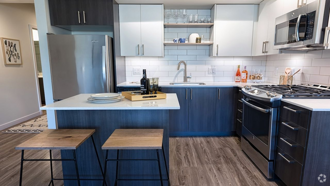 Our kitchens feature high-end finishes including stainless steel appliances and quartz countertops - Modera South Lake Union