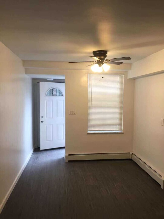 Entrance with ceiling fan and coat closet behind front door. - 3212 73rd St