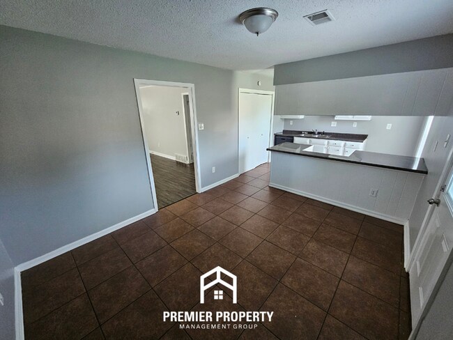 Building Photo - Charming 3BR/2BA Near Kirby | Hardwood Floors, Rustic Fireplace & Large Yard