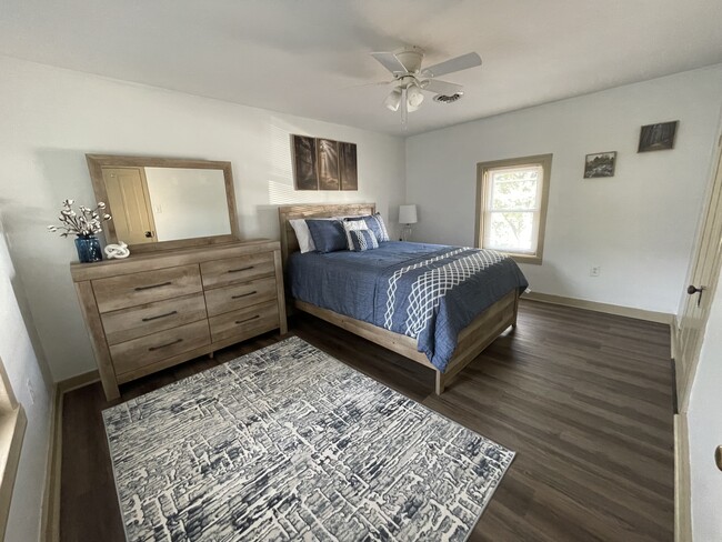 Bedroom with queen bed, dresser, nightstand, and 50" TV - 2312 Old Berwick Rd