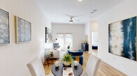 Located on McNeil Road in Austin, TX 78758, this well-designed one-bedroom, one-bathroom residence offers a smart, efficient layout across a single floor. Light hardwood flooring flows seamlessly throughout, lending warmth and continuity to every room.

The combined kitchen and living area forms the heart of the home. The kitchen is outfitted with crisp white cabinetry extending to the ceiling for ample storage, gray quartz-style countertops, a dark tile backsplash, and a full suite of stainless steel appliances including a refrigerator, range, microwave, and dishwasher. The adjacent living area is bright and airy, benefiting from natural light through window-blind-fitted windows and soaring wall height that lends the space an open, generous feel.

The bedroom is a calm, light-filled retreat with multiple windows dressed in white blinds, offering privacy while maintaining a bright ambiance. Clean white walls and hardwood floors create a serene atmosphere.

The bathroom is finished in a clean, contemporary style featuring a glass-enclosed walk-in shower lined with classic white subway tile, a white vanity with storage cabinetry above, and coordinating brushed nickel fixtures. The overall aesthetic of the residence is modern and cohesive, with a neutral palette that is both inviting and practical.