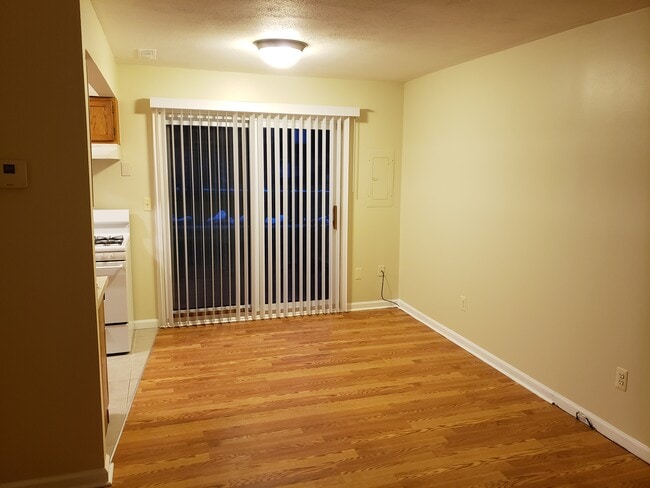 Dining room with laminate floors and access to the patio - 41177 S Woodbury Green Dr